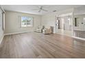 Bright living room with light wood floors and a neutral color palette, with an open view to the kitchen at 214 49Th W St, Bradenton, FL 34209