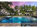 Relaxing pool and jacuzzi area with lounge chairs and mature trees for privacy and shade at 2202 Alpine Ave, Sarasota, FL 34239