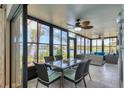 Sunroom with dining area and comfortable seating, offering beautiful views of the lake for relaxed dining at 308 Timber Lake Dr, Bradenton, FL 34210