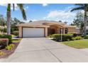 Inviting single-story home with a lush, green lawn and a spacious two-car garage at 3108 River Woods Dr, Parrish, FL 34219