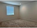 A bright, carpeted bedroom with a window offering natural light and electrical outlets conveniently placed at 3375 Juniper Springs St, Wesley Chapel, FL 33543