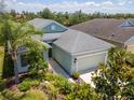 Aerial view of home with a two-car garage, well-maintained landscaping, and manicured lawn at 4529 Golden Gate Cv, Bradenton, FL 34211
