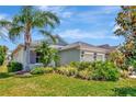 Charming single-story home featuring lush landscaping, a well-manicured lawn, and a cozy front porch at 4529 Golden Gate Cv, Bradenton, FL 34211