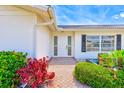 Inviting front entrance with a decorative walkway, complemented by colorful plants and a well-maintained facade at 4908 Commonwealth Rd, Palmetto, FL 34221