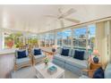 Enclosed sun room offering abundant natural light and scenic water views, with comfortable seating and coastal decor at 4908 Commonwealth Rd, Palmetto, FL 34221