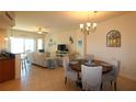 Bright living room with a dining area, cozy seating, and natural light at 501 Haben Blvd # 704, Palmetto, FL 34221