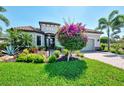 Tropical landscaping and manicured lawn enhance the curb appeal of this lovely home at 5437 Manchini St, Sarasota, FL 34238