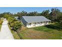 Beautiful aerial view showcasing a sprawling property with lush landscaping, large lawn, and serene surroundings at 6365 Jim Davis Rd, Parrish, FL 34219