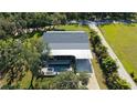 Backyard oasis with a sparkling pool, covered patio, and lush greenery creating a private retreat at 6365 Jim Davis Rd, Parrish, FL 34219