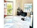 The entryway features neutral colored tile floors, a black salon chair, and a view of the front yard at 6442 Barberry Ct, Lakewood Ranch, FL 34202