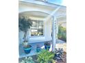 Inviting front porch adorned with potted plants, featuring pillars with the house number adding a personal touch at 6442 Barberry Ct, Lakewood Ranch, FL 34202