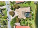 Aerial view of a private home with a screened-in pool and lush landscaping at 7011 Portmarnock Pl, Lakewood Ranch, FL 34202