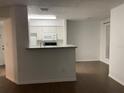Open-concept kitchen features granite countertops, stainless steel appliances, and a breakfast bar area at 8617 Fancy Finch Dr # 102, Tampa, FL 33614