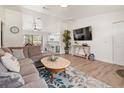 Bright and open living area with modern furnishings, wood floors, and a view to the kitchen at 9080 Caloosa Dr, Venice, FL 34293