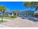 Charming home features a well-manicured lawn, lush landscaping, and a long driveway leading to a 3 car garage at 10411 Winding Stream Way, Bradenton, FL 34212