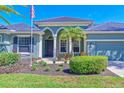 Charming home features a well-manicured lawn, lush landscaping, with a walkway leading to an arched front entrance at 10411 Winding Stream Way, Bradenton, FL 34212