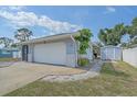 Exterior angle view showing the home's garage, storage shed, and meticulous landscaping at 108 Stanford Rd, Venice, FL 34293