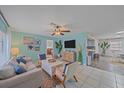 Inviting living room boasts tile floors, coastal decor, and an open layout leading into the kitchen at 108 Stanford Rd, Venice, FL 34293