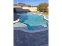 The in-ground swimming pool is surrounded by a modern gray brick patio and a well manicured lawn at 1118 Wynnmere Walk Ave, Ruskin, FL 33570