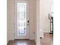 Elegant foyer featuring a decorative glass door and tile flooring, offering a bright welcome at 11510 Sweetgrass Dr, Bradenton, FL 34212