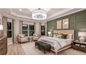 Luxurious main bedroom with decorative wall paneling and large windows filling the room with light at 14907 Contenta Loop, Bradenton, FL 34211