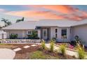 Inviting single-story home featuring decorative stone accents, meticulously maintained landscaping, and an attractive front entrance at 1724 Cheyenne St, Sarasota, FL 34231