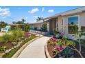 Beautifully landscaped front yard with a curving walkway leading to the front door, with tasteful plantings and garden edging at 1724 Cheyenne St, Sarasota, FL 34231