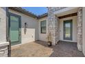 Covered front entrance featuring brick pavers, stone accents, and decorative front door at 1907 Woodleaf Hammock Ct, Bradenton, FL 34211