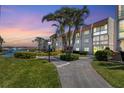 Condo building with landscaped grounds and a walkway leading to the entrance at 210 Santa Maria St # 244, Venice, FL 34285