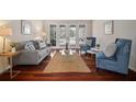 Bright living room with hardwood floors, French doors, and comfortable seating arrangement perfect for relaxation at 21616 67Th E Ave, Bradenton, FL 34211