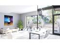 Bright living room features an open floor plan, modern furniture, and sliding glass doors leading to a patio at 2170 Robinhood St # A1-302, Sarasota, FL 34231