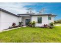 Well-maintained home featuring fresh landscaping, stone pathway and neutral colors at 2231 Hagoplan Ln, North Port, FL 34288