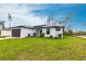Stylish home offering an attached two-car garage and well-manicured front lawn at 2231 Hagoplan Ln, North Port, FL 34288