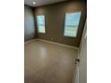 Well-lit bedroom with tile flooring, and a view to the outside at 24835 Buckingham Way, Port Charlotte, FL 33980