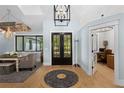 Inviting entryway with hardwood floors, decorative rug, and view of outdoor landscape at 25305 83Rd E Ave, Myakka City, FL 34251