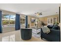 Bright living room featuring large windows, stylish curtains, and comfortable seating arrangements at 2708 Fort Worth St, Sarasota, FL 34231