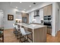 Modern kitchen featuring a large island with seating, stainless steel appliances, and sleek cabinetry at 301 Quay Commons # 503, Sarasota, FL 34236