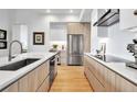 Well-designed kitchen with stainless steel appliances, quartz countertops, and wood-grain cabinets at 301 Quay Commons # 503, Sarasota, FL 34236