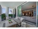 Cozy balcony with outdoor seating area, stylish rug, and serene views of the cityscape and bay at 301 Quay Commons # 611, Sarasota, FL 34236