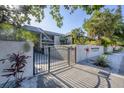 The Oasis on Osprey gated condominium entrance with lush tropical landscaping at 3350 S Osprey Ave # 211A, Sarasota, FL 34239