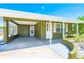 The front exterior features a covered carport with access to the home's entrance at 3427 Cambridge Dr, Sarasota, FL 34232