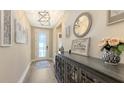 Stylish entryway with wood floors, decorative accents, and a charming 'Gather Together' sign at 3803 Savanna Palms Ct, Bradenton, FL 34211