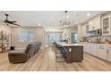 Open-concept kitchen with granite countertops, stainless steel appliances, and a center island with seating at 3803 Savanna Palms Ct, Bradenton, FL 34211