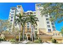 Stunning exterior of building at 385 featuring palm trees, covered parking and gorgeous architecture at 385 N Point Rd # 903, Osprey, FL 34229