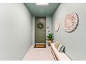 Inviting entryway with a decorative door, stylish accents, and a bench for seating with muted colors at 388 Aruba Cir # 103, Bradenton, FL 34209