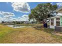 Expansive backyard featuring a serene pond, lush greenery, and a spacious area for outdoor enjoyment at 3909 40Th W St, Bradenton, FL 34205