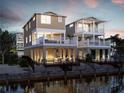 Inviting waterfront homes featuring multi-level balconies and outdoor seating areas for relaxation at 4206 Saltwater Pearl Way, Cortez, FL 34215