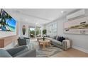 Bright living room featuring coastal decor, shiplap ceilings, and a comfortable sectional sofa at 4206 Saltwater Pearl Way, Cortez, FL 34215