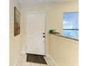 Bright entry foyer with tile floors, white door, and natural light from window at 428 40Th W Ct, Palmetto, FL 34221