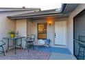 Inviting outdoor patio includes a table, chairs, and a view of the front door at 428 40Th W Ct, Palmetto, FL 34221